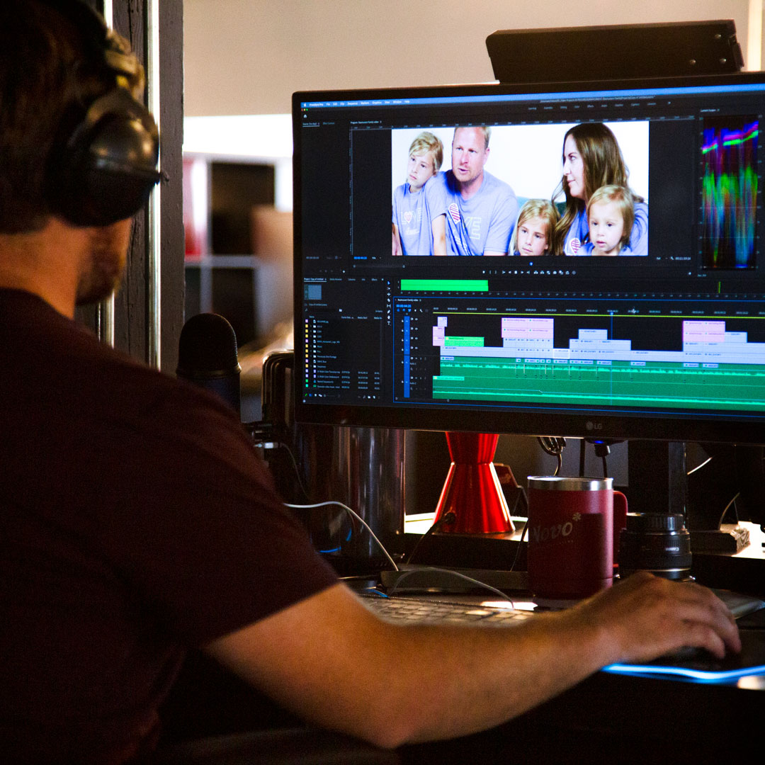 de Novo video producer Andrew editing a video
