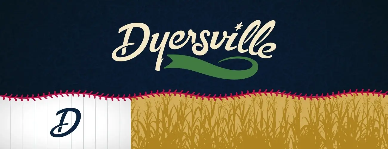 Dyersville logo featuring stylized text with a green swoosh and a corn field illustration below