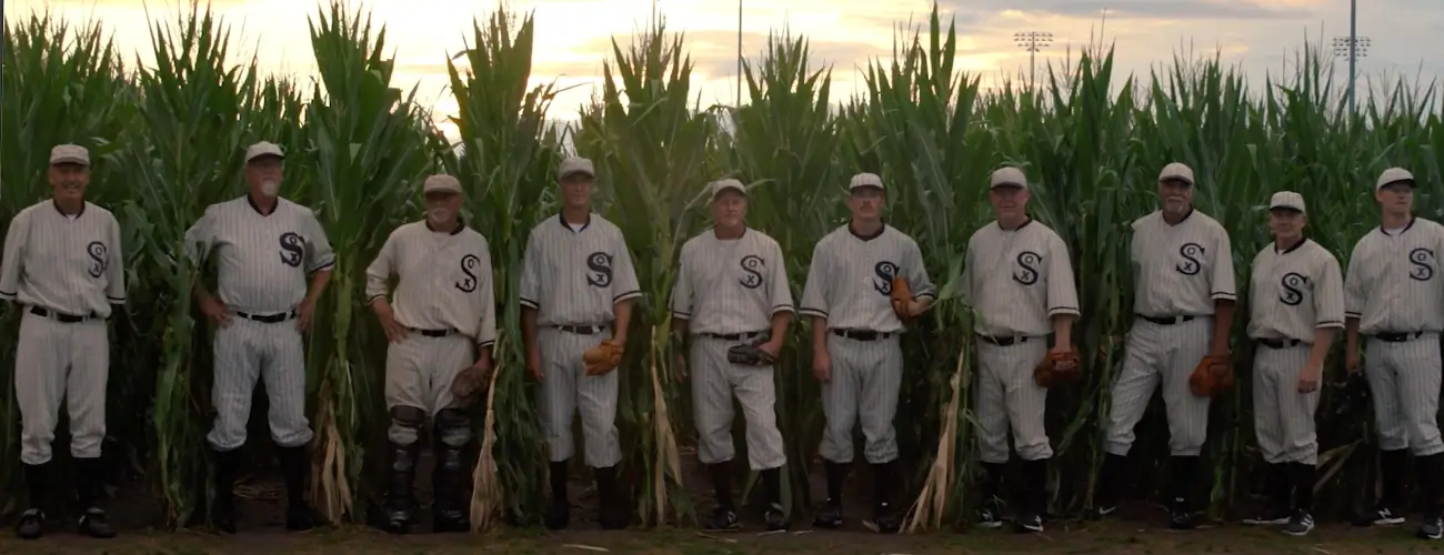 Ten baseball players in vintage Chicago White Sox uniforms standing in a cornfield, referencing the classic film Field of Dreams