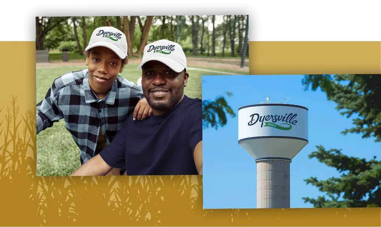 Man and child wearing Dyersville caps smile together in a park, representing community connection for a full-service marketing agency