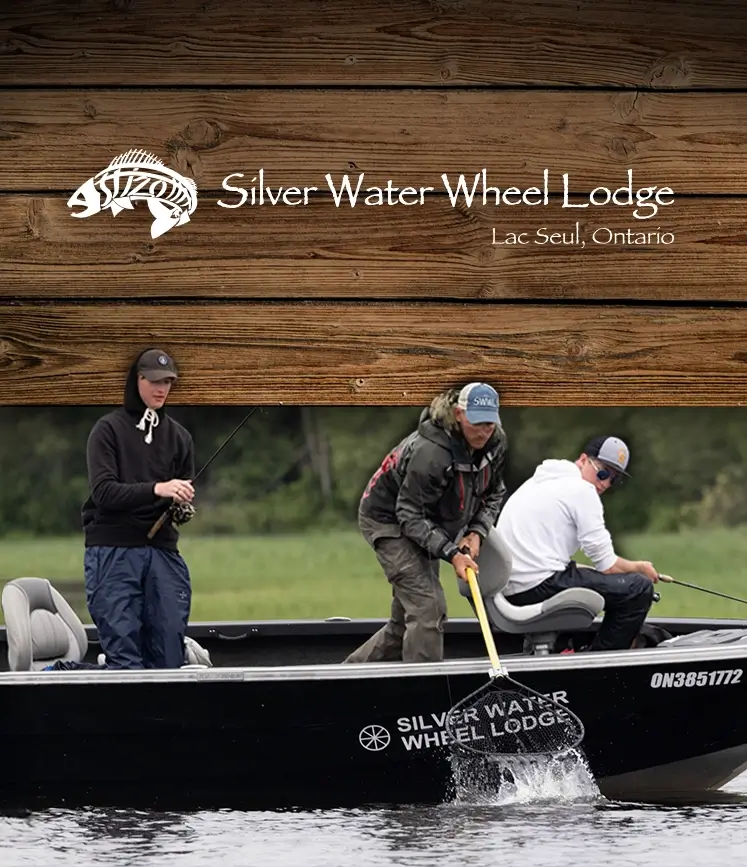 Three people fishing from a branded Silver Water Wheel Lodge boat on a lake in Lac Seul, Ontario